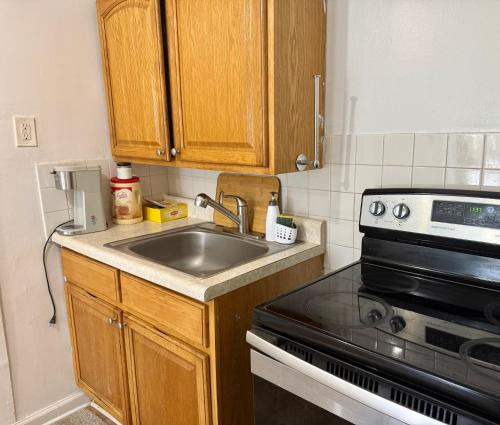 a kitchen with a sink and a stove at 2265 Bruckner Blvd Apartments in Bronx