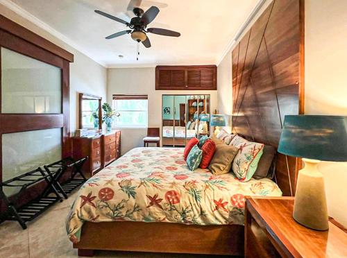 a bedroom with a bed and a ceiling fan at Ocean One - Harmony! in Cabarete