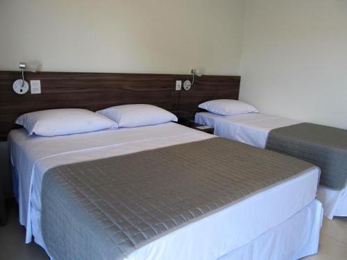 Postel nebo postele na pokoji v ubytování Portal Hotel Mogi Mirim