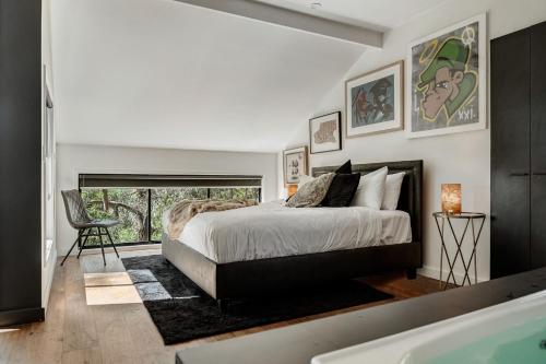 a bedroom with a large bed and a bath tub at Istana Indulge in Hepburn Springs