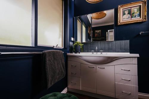 a bathroom with a sink and a mirror at Istana Lodge in Musk Vale