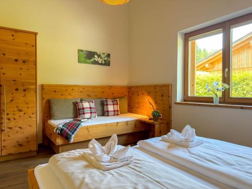 a bedroom with two beds and a window at Trebas 51 in Lake Pressegg