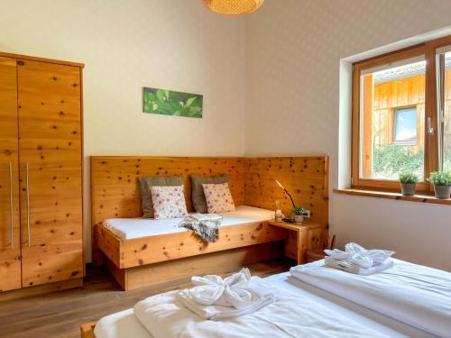 a bedroom with two beds and a window at Bellone 52 in Lake Pressegg