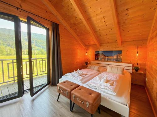 a bedroom with a bed and a large window at Rattendorf 23A in Rattendorf