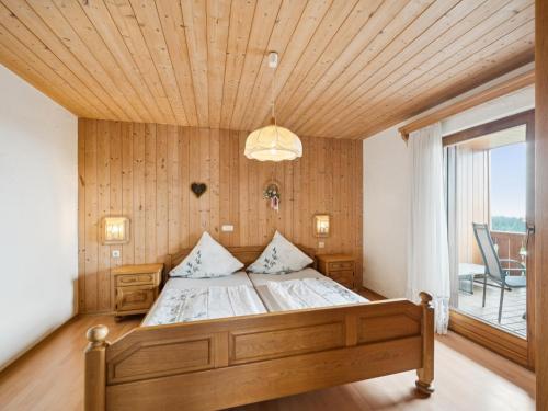 a bedroom with a bed with a wooden ceiling at Max in Waldkirchen