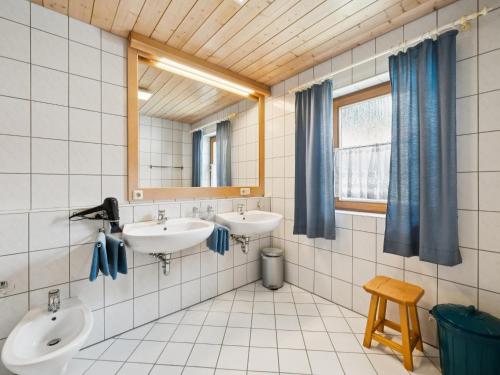 a bathroom with two sinks and a mirror at Max in Waldkirchen