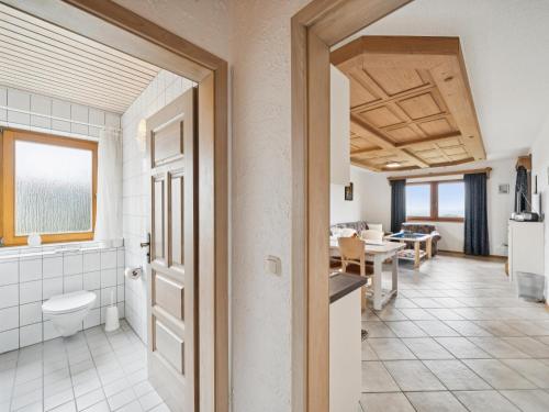 a bathroom with a toilet and a kitchen with a dining room at Hans in Waldkirchen