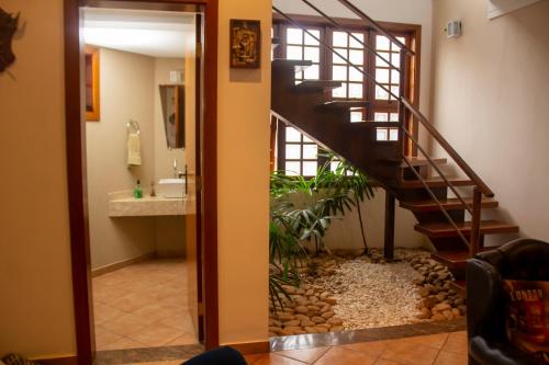 a bathroom with a staircase leading to a bathroom with a sink at Hostel Terraço Urbano in Sao Jose do Rio Preto