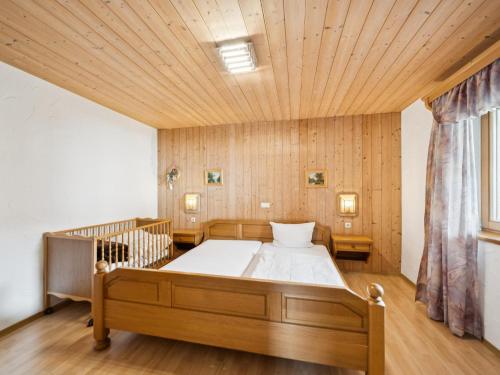 a bedroom with a large bed with a wooden ceiling at Hans in Waldkirchen