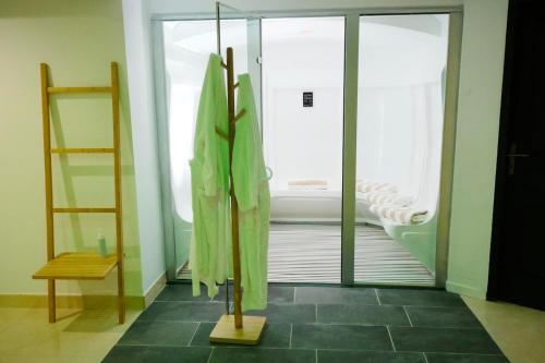 a bathroom with a shower and a glass door at Bien plus qu un séjour Une expérience à vivre in Mondragon