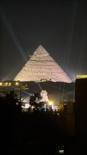 a view of the pyramid at night at Prince Pyramid HoteLL in Cairo