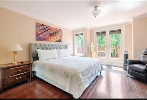 a bedroom with a bed and a couch and a chair at Unique Home - Upper Toronto Beaches in Toronto