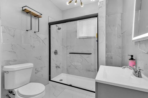 a bathroom with a shower and a toilet and a sink at 4BR Apt Pool Table Sleeps 9 Buffalo in Buffalo