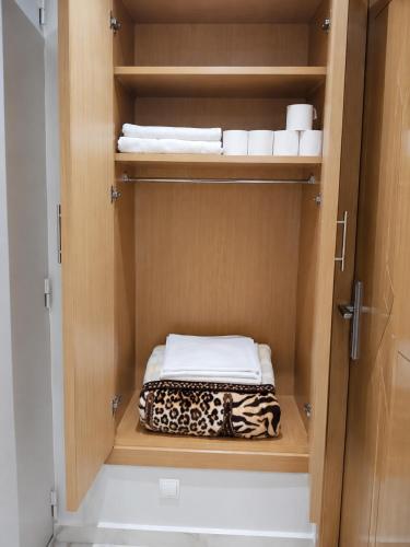 a cupboard with towels and towels in a bathroom at Modern Studio Hassan Rabat in Rabat