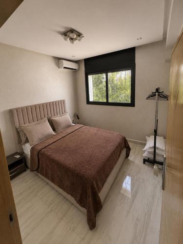a bedroom with a large bed and a window at Modern Studio Hassan Rabat in Rabat