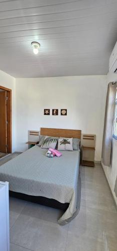 a bedroom with a bed with a pink robe on it at recanto Provetá 1 ILHA GRANDE in Praia de Provetá 