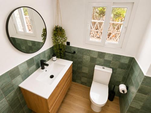 a bathroom with a sink and a toilet and a mirror at Apartamento Torrox Village 2 in Torrox