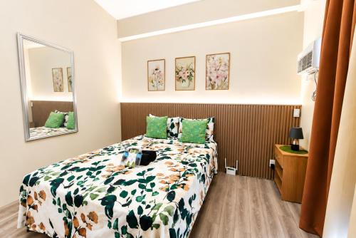 a bedroom with a bed and a mirror at 2 Mins Away from Mactan Cebu Airport in Pusok