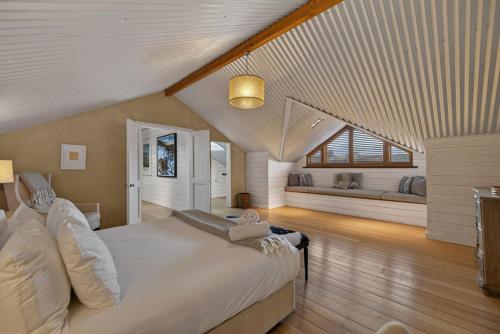 a large bedroom with a large bed and a window at Toi Point Lodge in Queenstown