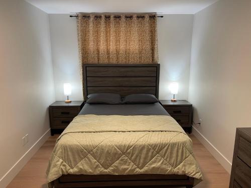 a bedroom with a large bed with two night stands at Orgive Suite - Private 1 Bedroom Apartment in Riverview
