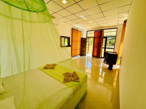 a bedroom with a bed with bows on it at Traveller's Home Safari Resort in Udawalawe