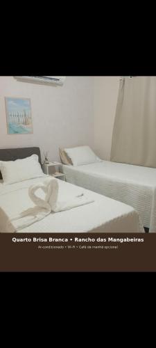 two beds sitting next to each other in a bedroom at Rancho das mangabeiras in Mata de Sao Joao