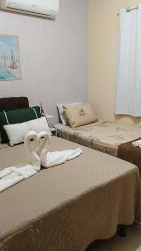 two beds with swans towels on them in a room at Rancho das mangabeiras in Mata de Sao Joao