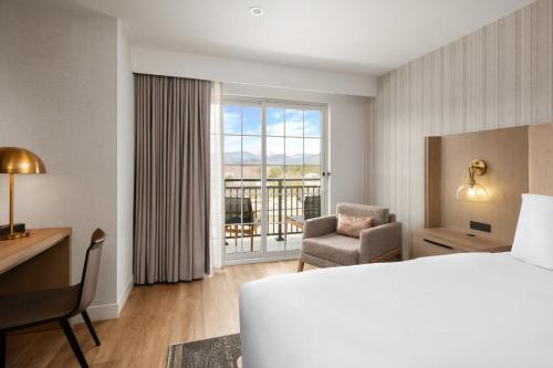 a hotel room with a bed and a chair and a window at Hotel Indigo North Conway by IHG in North Conway