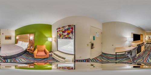 a hotel room with a bedroom with a bed and a room at Quality Inn Walterboro I-95 in Walterboro
