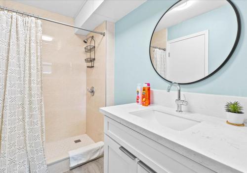 a bathroom with a sink and a mirror at One Bed Honolulu Kaaha in Honolulu
