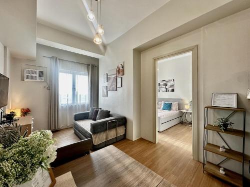 a living room with a couch and a mirror at 8F Cozy 1-Bedroom Unit The Loop Towers in Cagayan de Oro