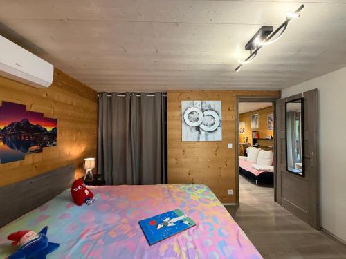 a bedroom with a large bed and a room with a bed sqor at Source Olympique Alpes in Gilly-sur-Isère