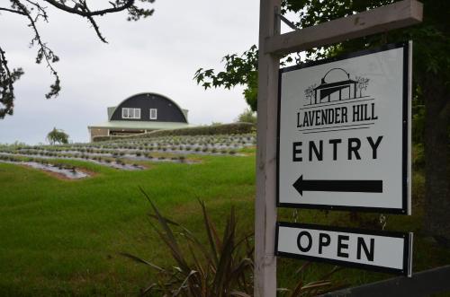 a sign in front of a field with a farm at Lavender Hill in Riverhead