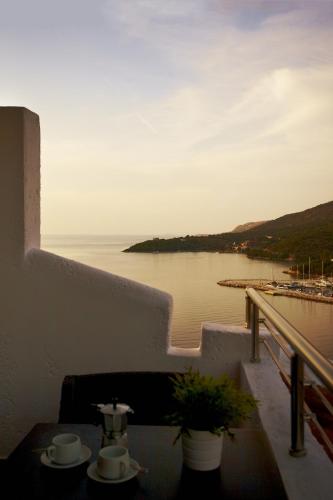 a balcony with a view of a body of water at Panorama Botsaris Apartments in Sivota