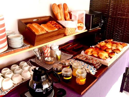 a buffet with bread and pastries and other food items at サンシティーホテル山代 in Kaga