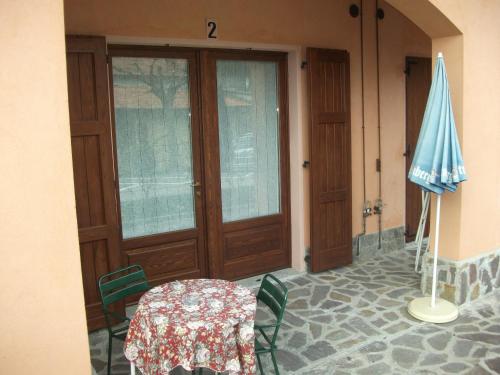 a dining room with a table and a blue umbrella at Albergo Breglia in Plesio
