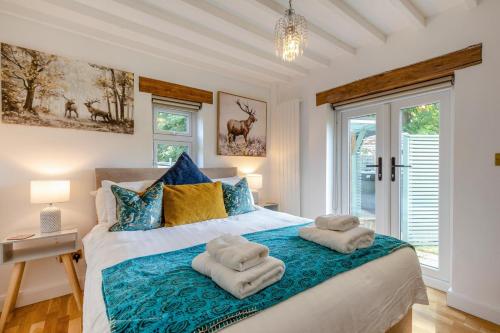 a bedroom with a large bed with towels on it at 3 Bed in Bakewell oc-96293 in Baslow