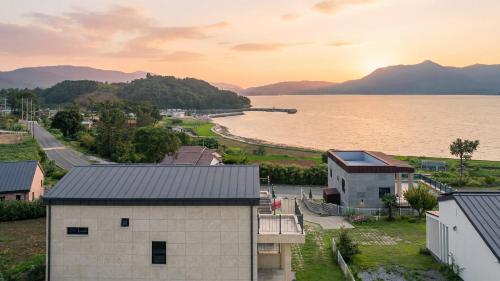 an aerial view of a town with a body of water at That Day's Namhae Ocean View Pension in Namhae