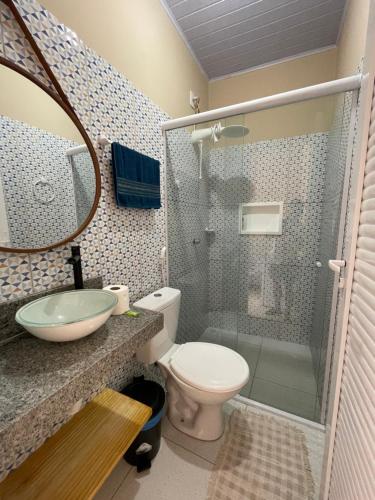 a bathroom with a shower and a toilet and a sink at Casa Dona Vilma in Barreirinhas
