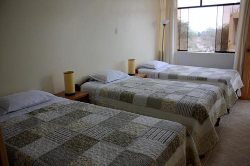 Ένα ή περισσότερα κρεβάτια σε δωμάτιο στο Hospedaje Dulce Estancia