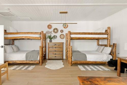 a bedroom with two bunk beds and a table at Lakefront View Stunner in Big Bear Lake