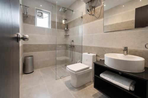 a bathroom with a toilet and a sink and a shower at The Amber Signature Vrindavan # A Luxury Apartment With #Lift# Garden # Parking# Ac Rooms# & Elegant interior # Located Inside- Omaxe Eternity Vrindavan in Vrindāvan
