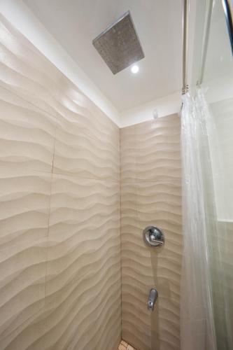 a bathroom with a shower with a shower curtain at Beachfront Bliss at Isla Verde in San Juan