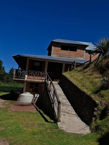 a brick house with a staircase leading up to it at Rancho buena vista in Mineral del Chico