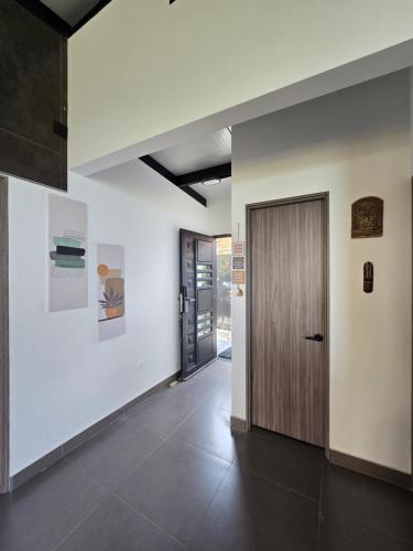 a hallway with a wooden door in a building at Chalet - ENCANTO - Donde la Tranquilidad tiene la mejor Vista in El Cerrito