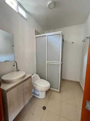 a bathroom with a toilet and a sink and a shower at Casa blue in Rodadero