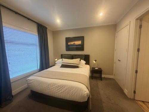 a bedroom with a large bed and a window at Cardrona Mountain Villa in Cardrona