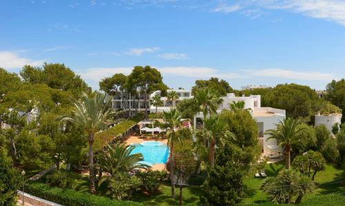 an aerial view of a resort with a pool and trees at Meliá Cala d'Or Boutique Hotel in Cala d´Or