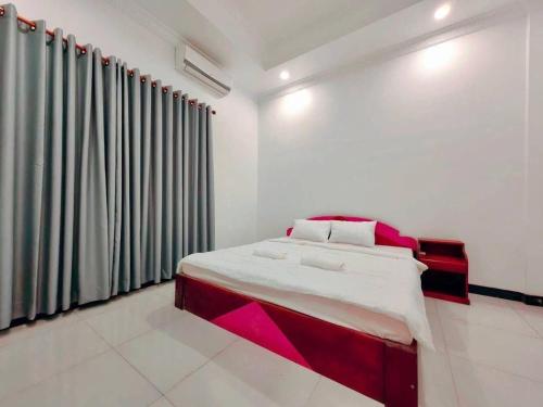 a bedroom with a bed with red and white at Peace And Cool Hotel in Siem Reap