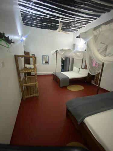 a bedroom with two bunk beds and a ladder at Tonys homestay in Zanzibar City